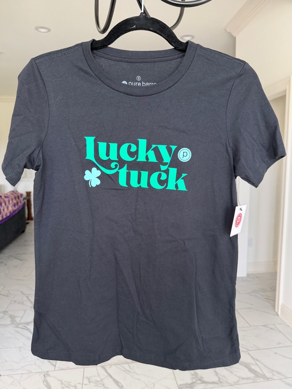 Pure Barre Black Tee with Green 'Lucky Tuck' Logo